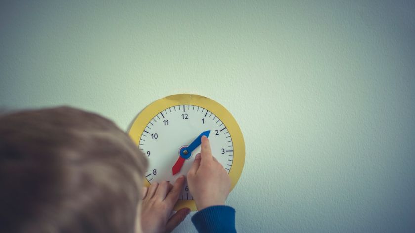 Boy with play clock for adjust