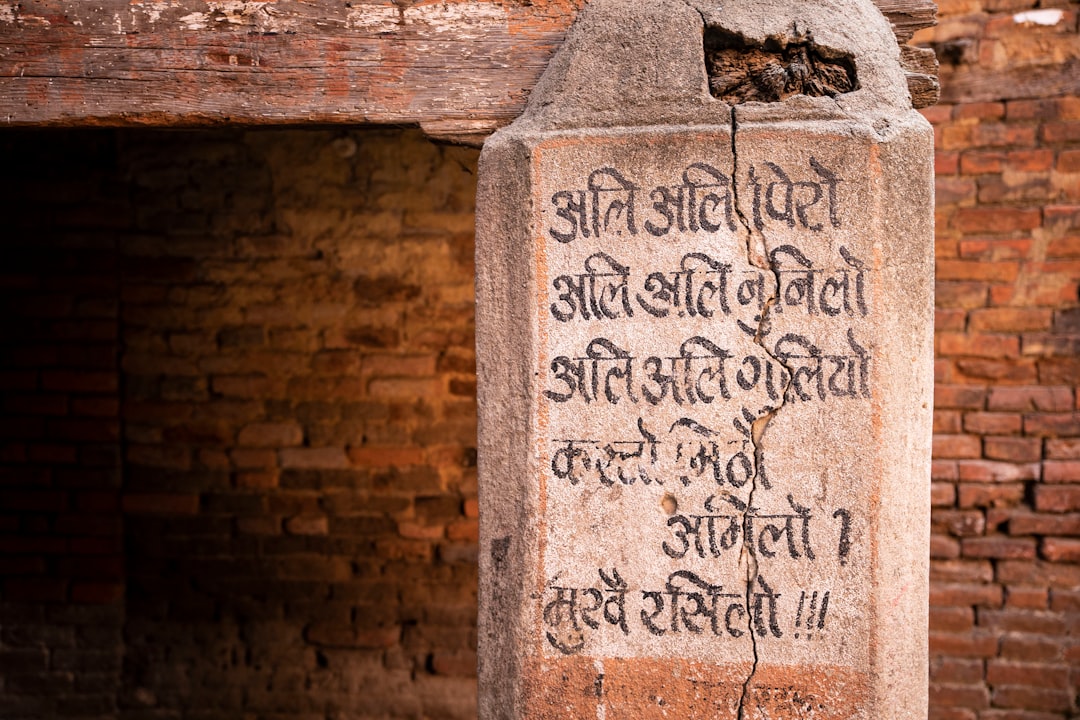 Old script carved into stone on a building in Bhaktapur, Nepal www.littleleafcreative.com